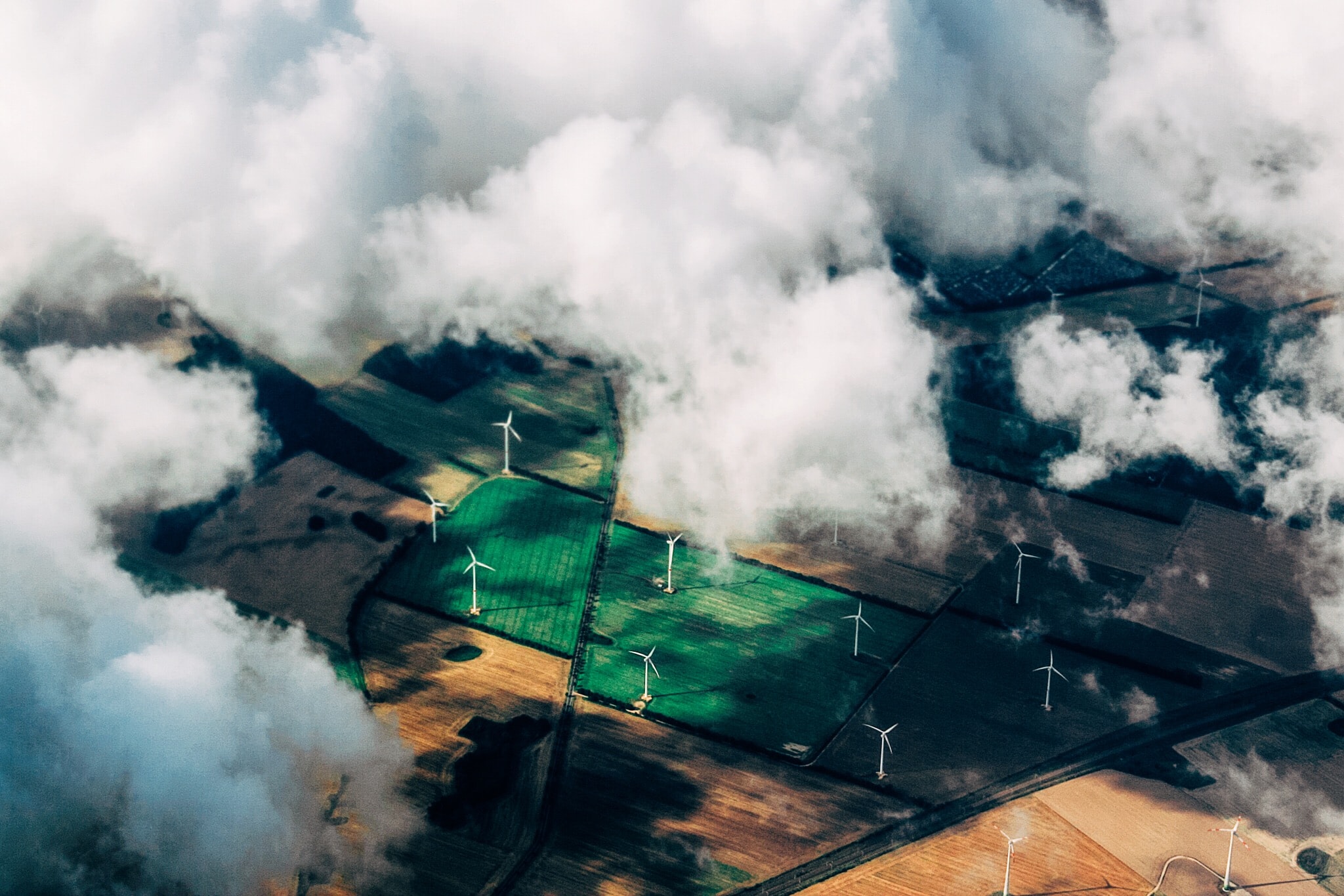 windmills viewed in cloudy sky